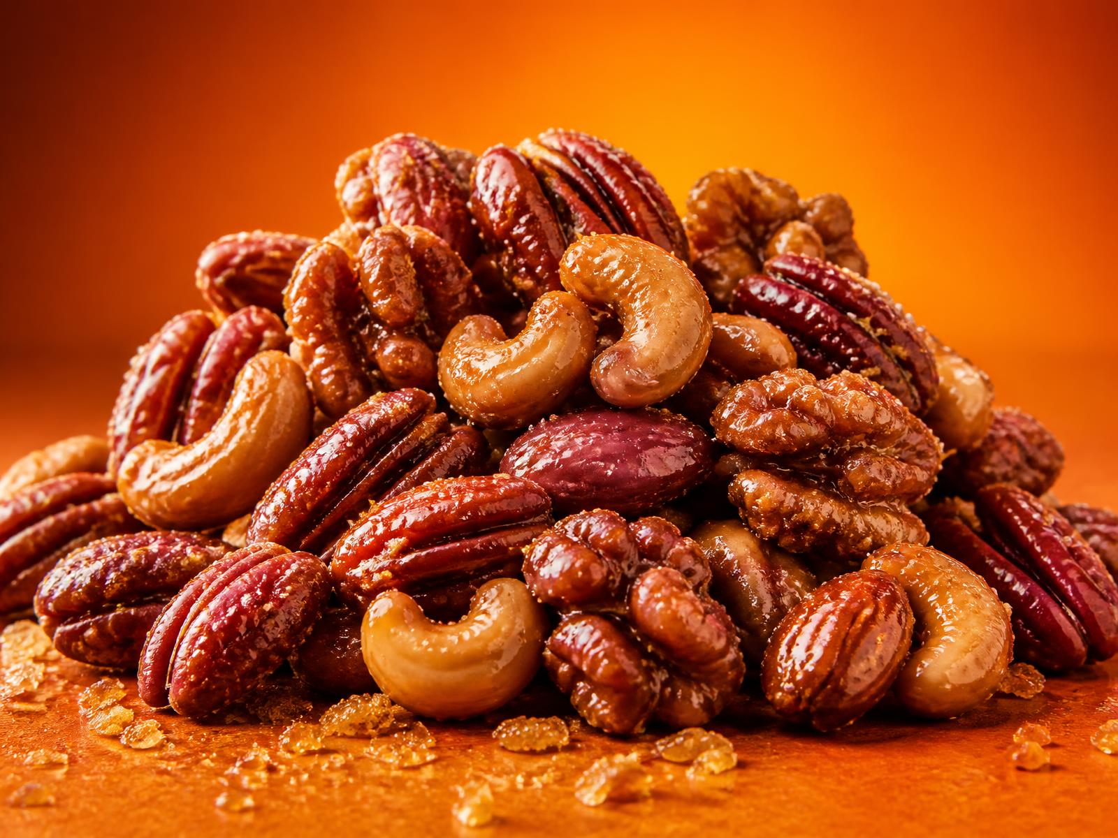 A pile of glossy caramelized mixed nuts